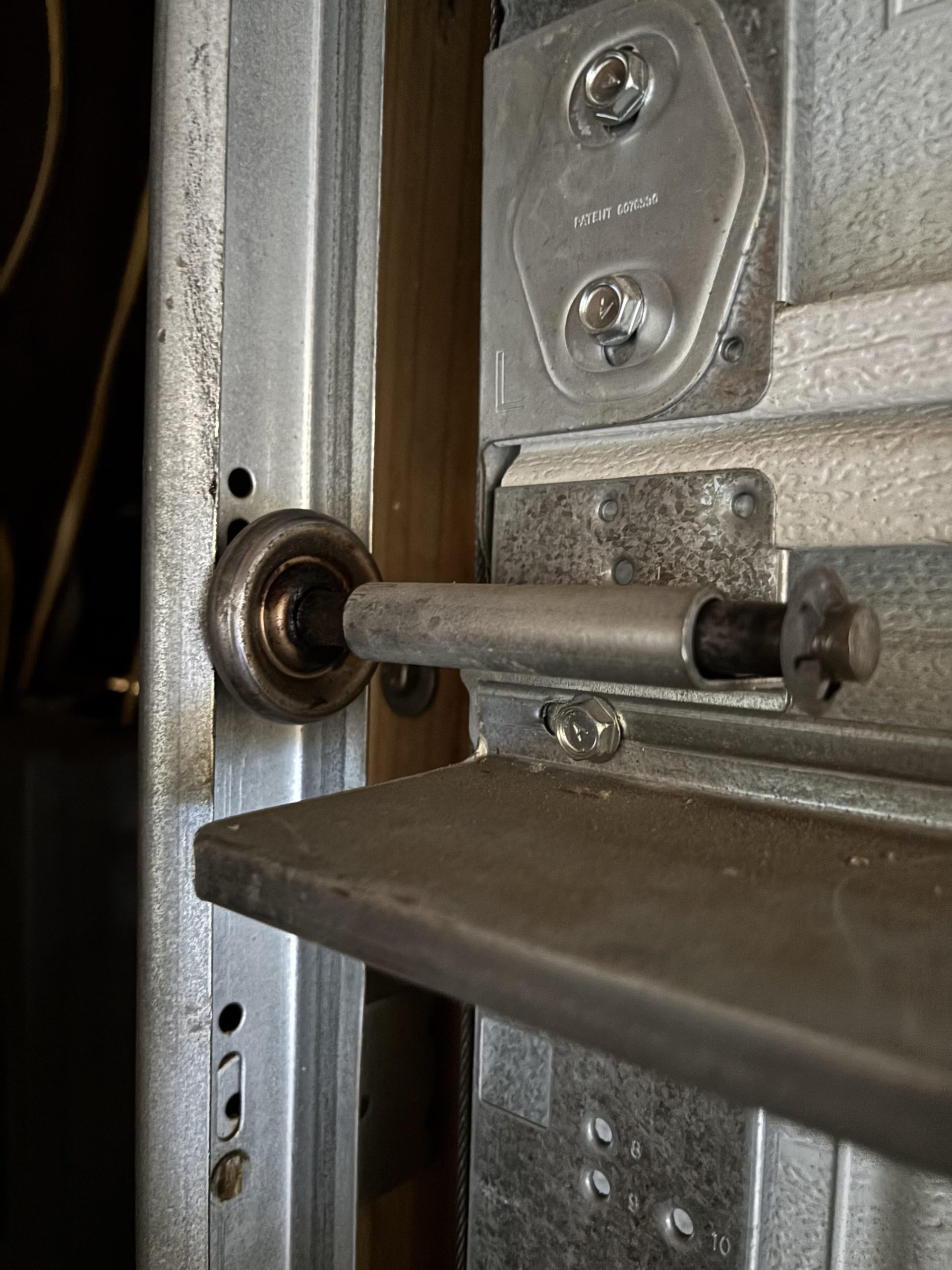How To Put A Garage Door Wheel Back On Track